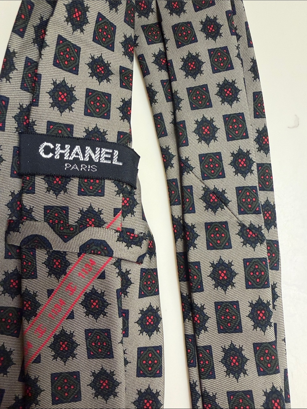 CHANEL Greyge Silk Tie with Navy Motif and Red Accents